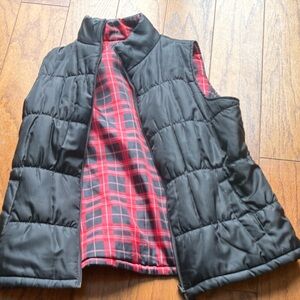 Black vest with plaid inside. It is reversible.